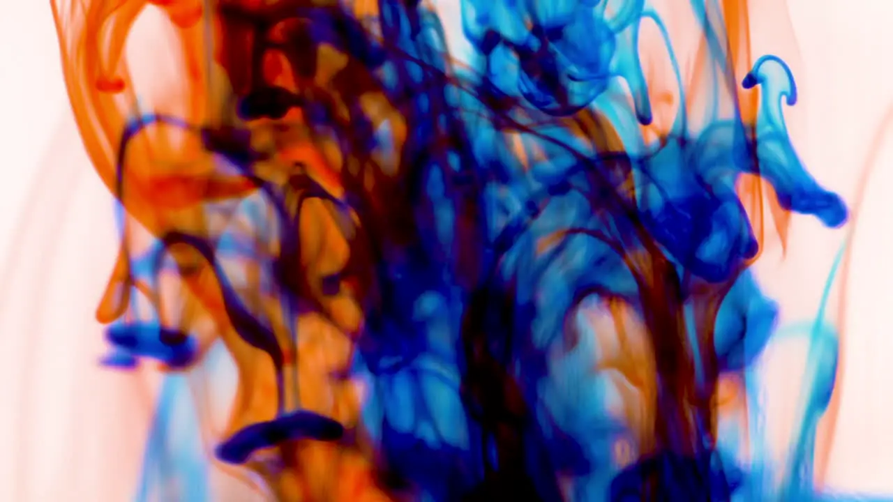 Super slow motion abstract flow of colors mixing together