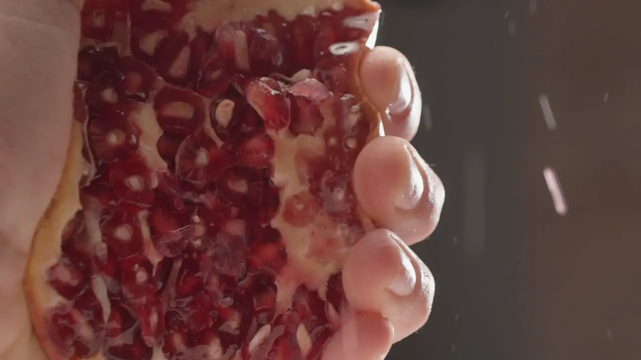 Squeezing juicy pomegranate