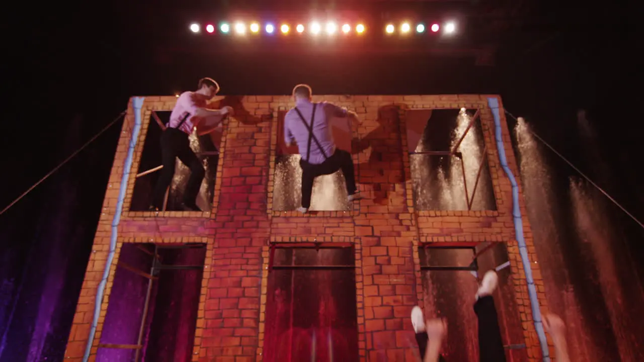 Three men jumping on trampoline in the circus