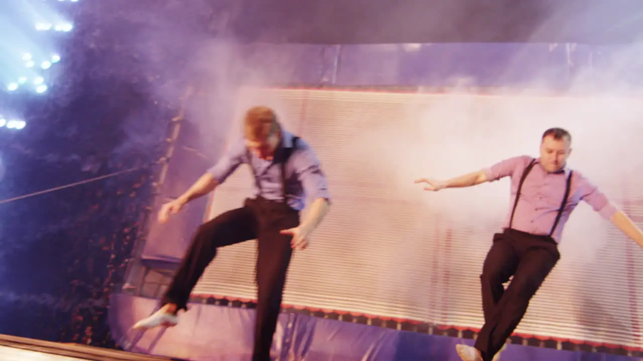 Men performing on trampoline in the circus