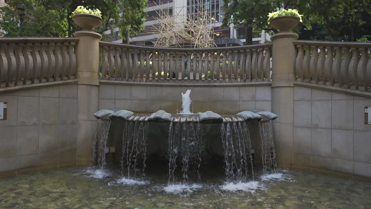 Slow motion shot of a fountain in a city during the day