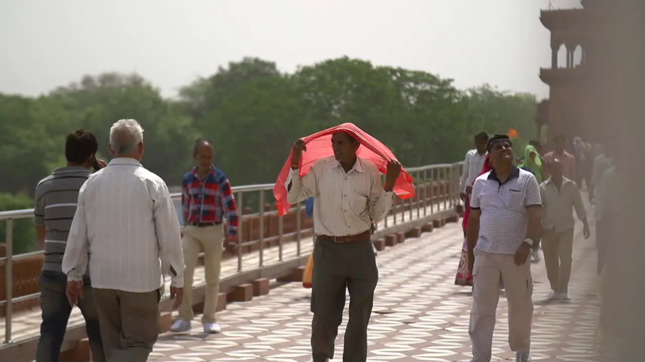 Man Covering Head With Red Shawl