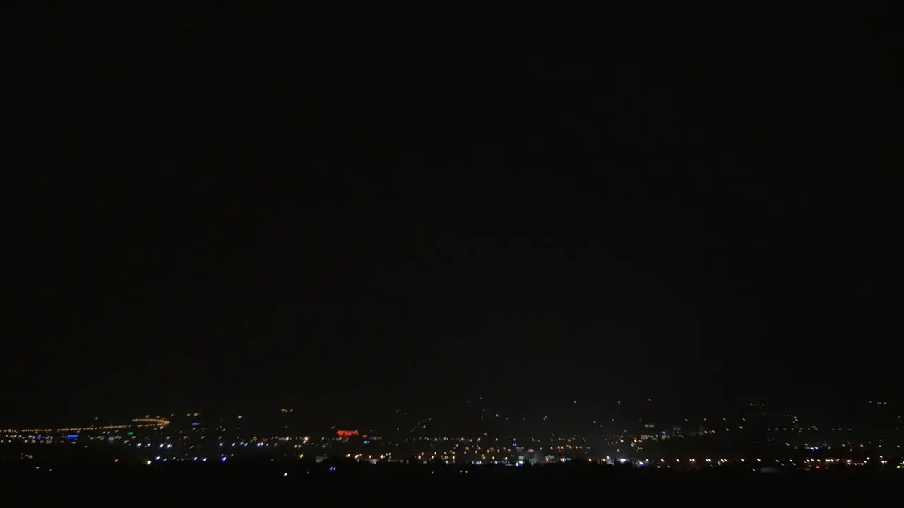 Lightning strikes over the city at night