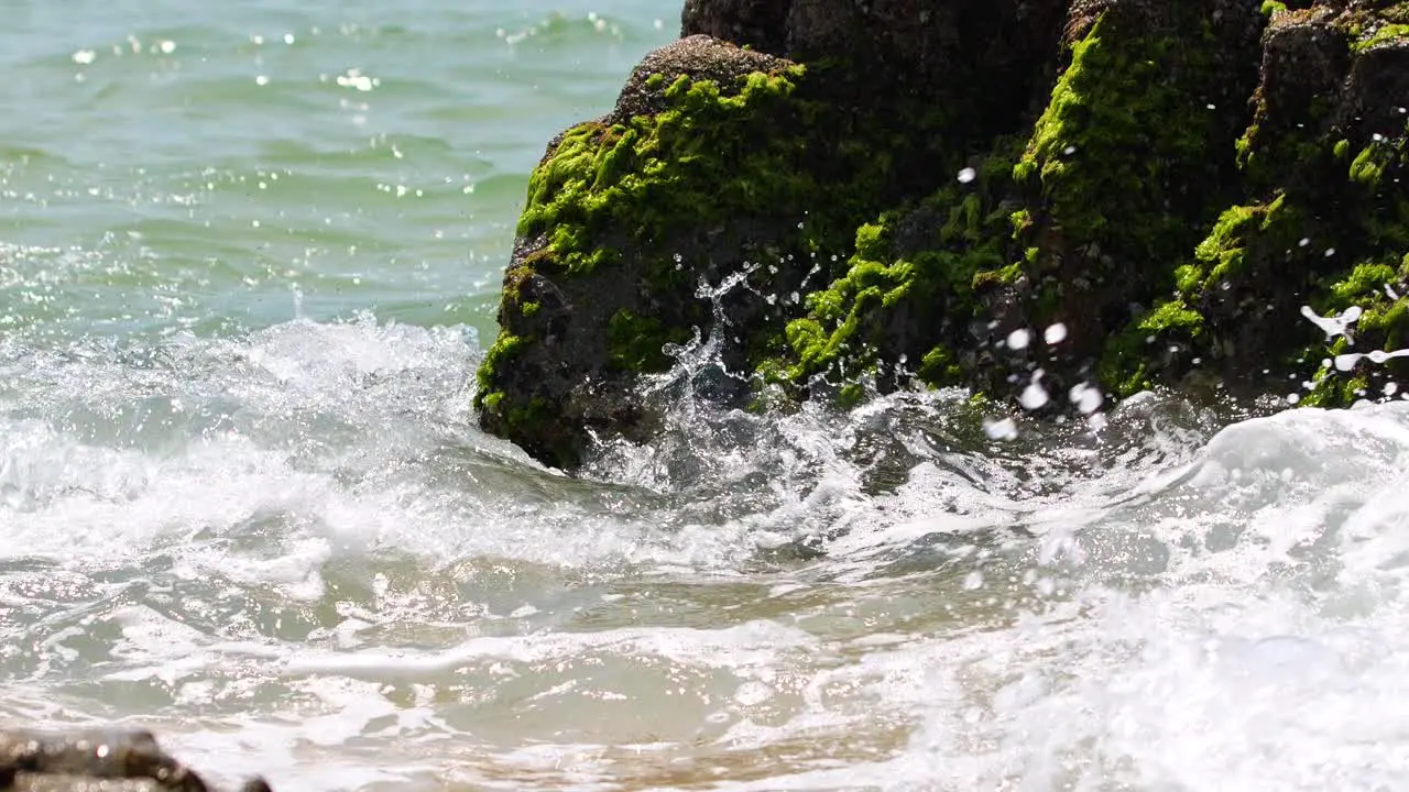 waves crashing on the pumice stone shore splashing