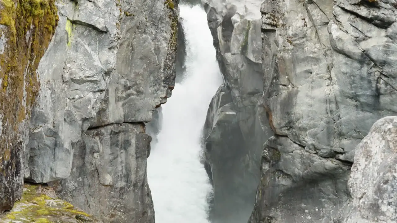 Slow motion tilt down shot of powerful waterfall