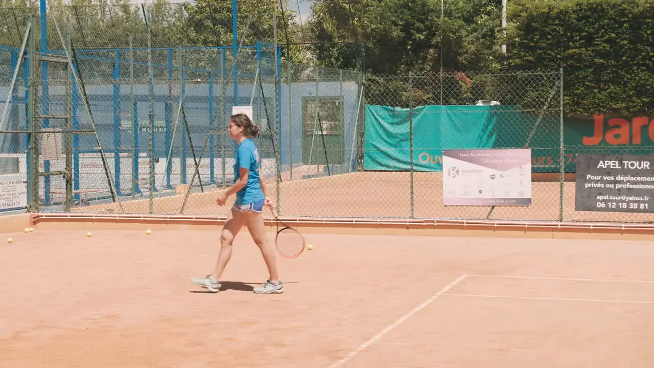 Tennis girl bounce a ball with racket and walk away slow motion