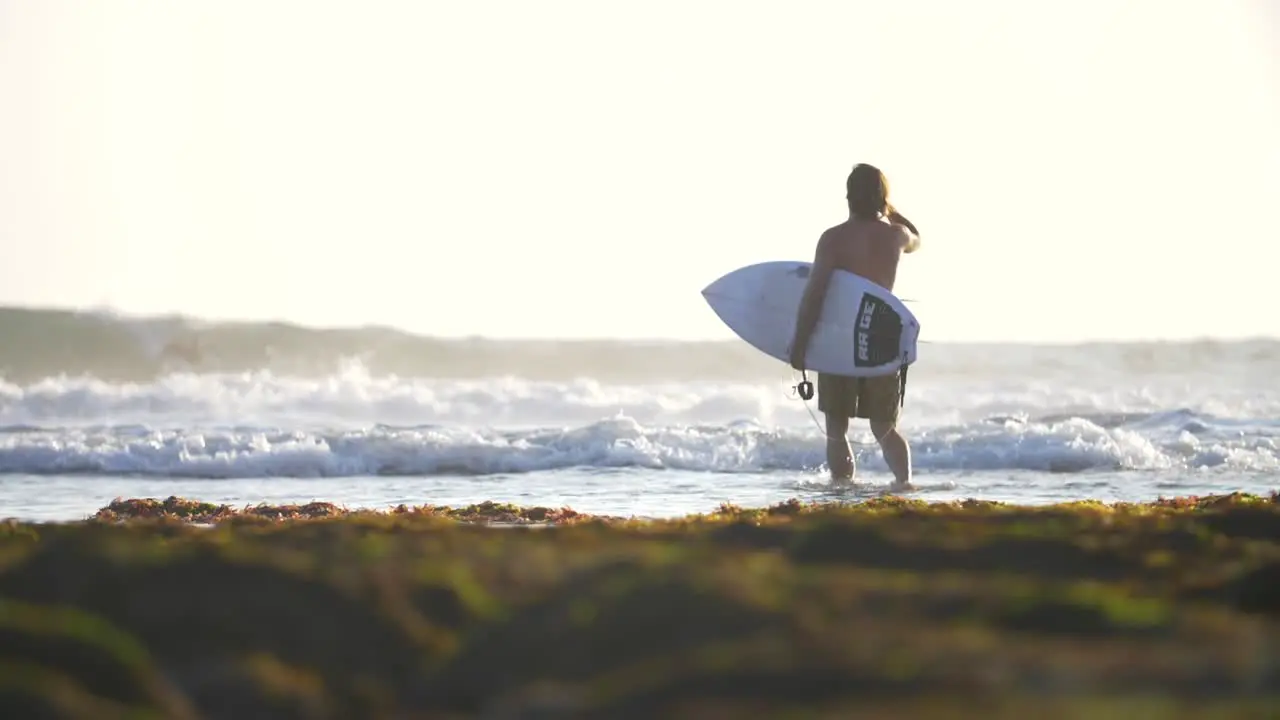 Surfer Entering the Ocean