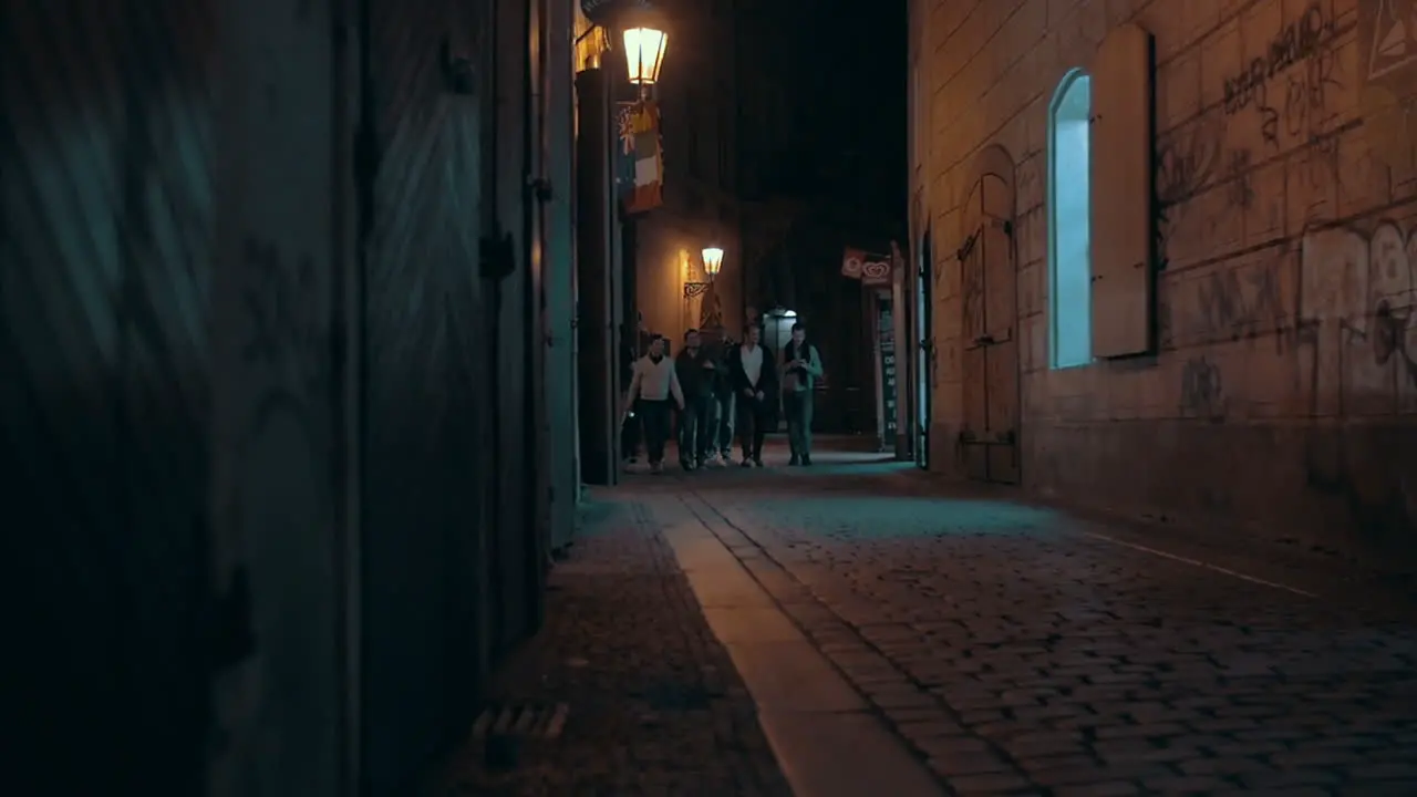 Group of men walking in night Prague