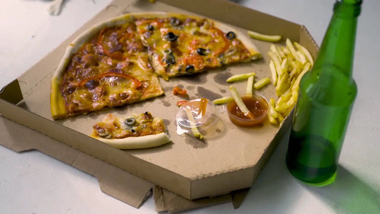 Delicious Pizza With Black Olives And Red Peppers French Fries With Tomate Sauce And Empty Beer Bottle