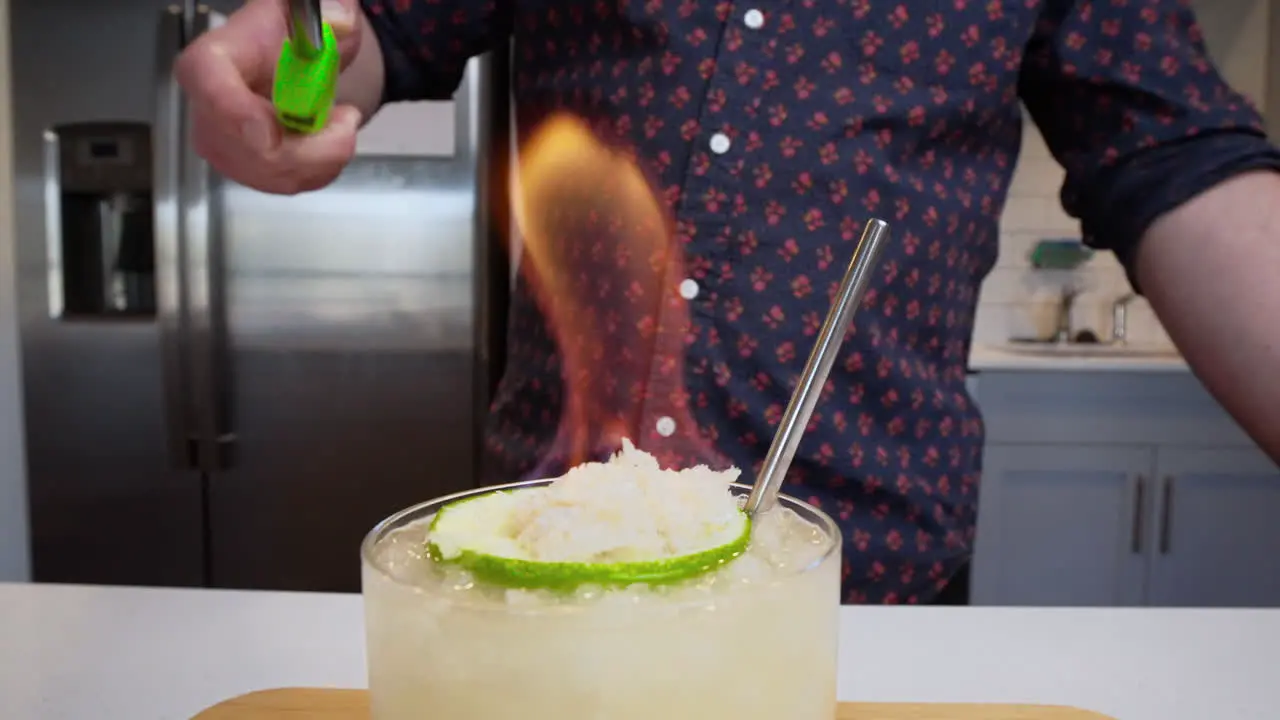 Bartender lights fire for flaming cocktail in slow motion