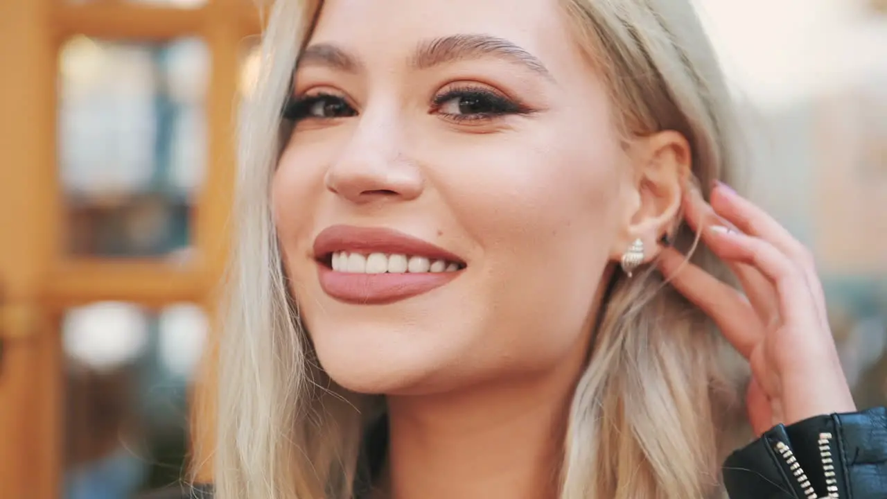 Portrait Of Pretty Young Blonde Woman In Makeup With Painted Lips And Manicure Looking At Camera