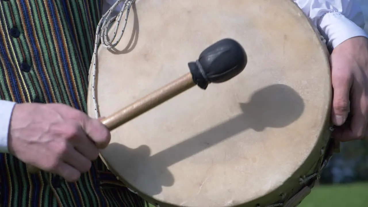 Latvian Boy in Folk Costume Drumming in Slow Motion