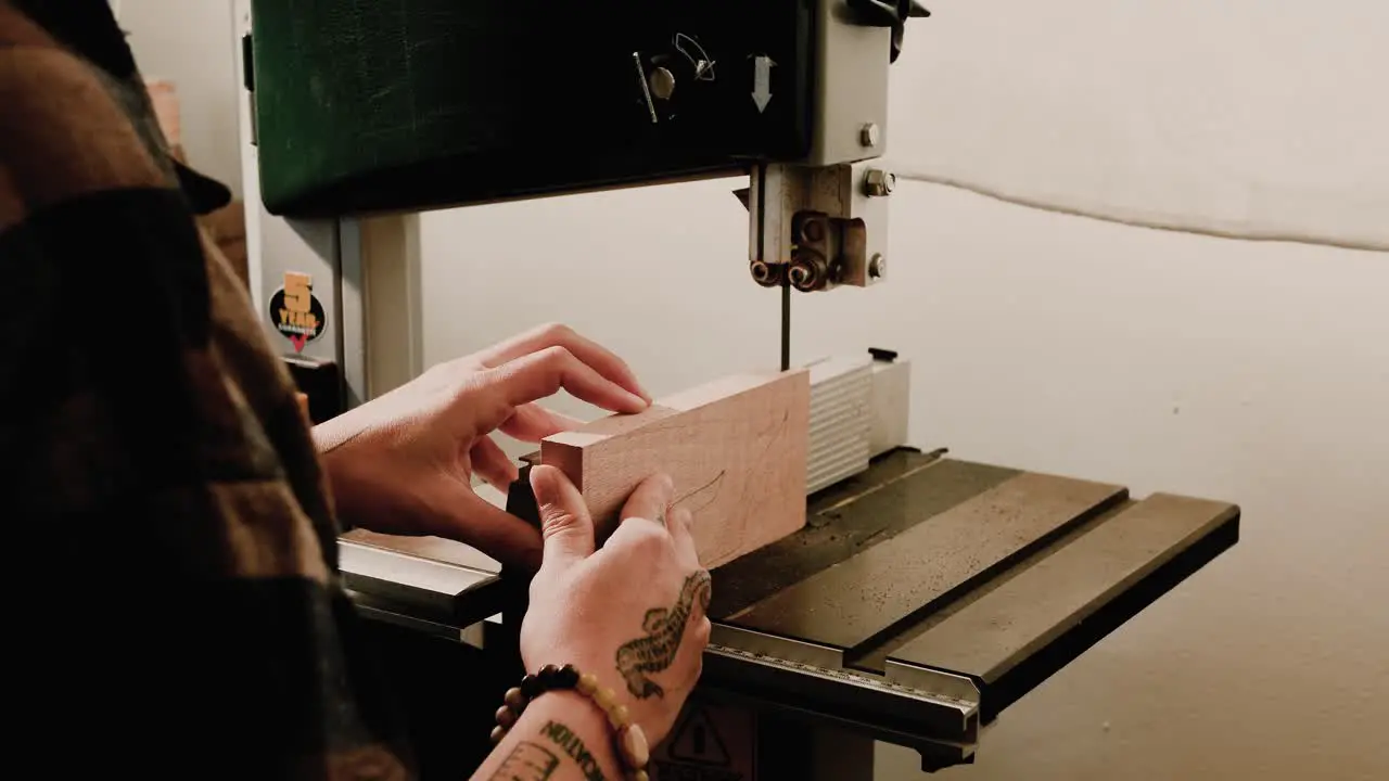 Female artist cutting wood on bandsaw woodworking 4K slow motion 60 fps