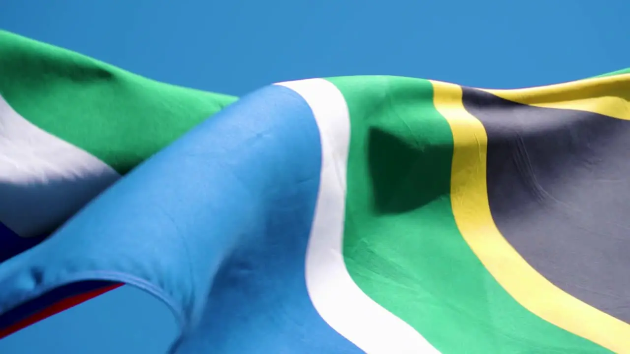 Close up shot of a South African flag flapping in slow motion at 120fps