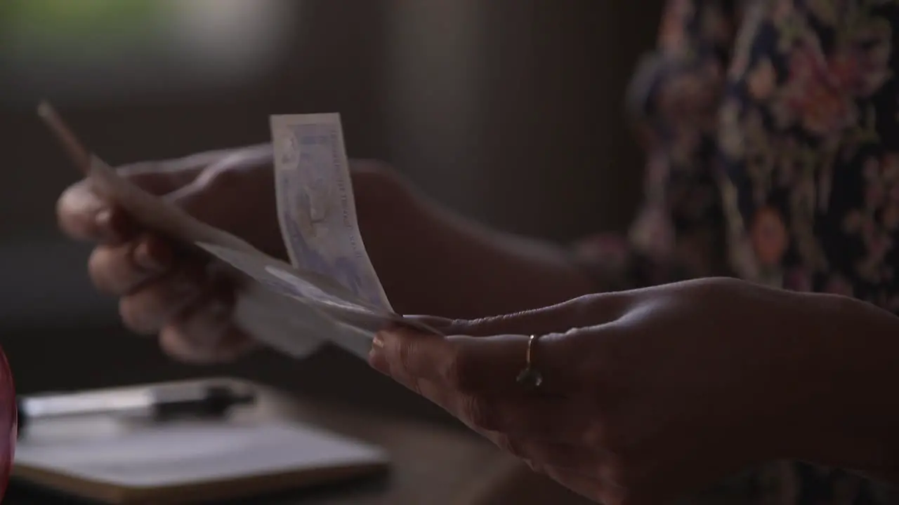 Women counting money cash notes in SLOW MOTION