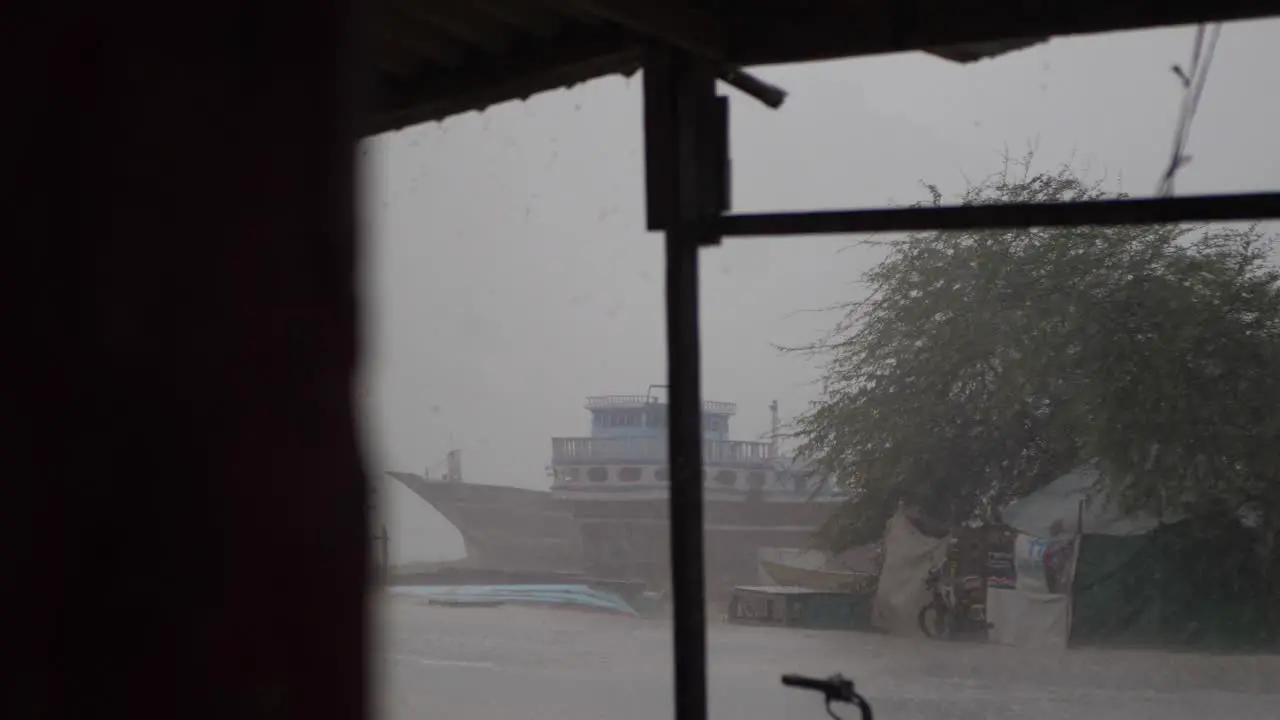 Looking Through Window At Heavy Rain Falling At Gwadar Fishing Port On Overcast Day