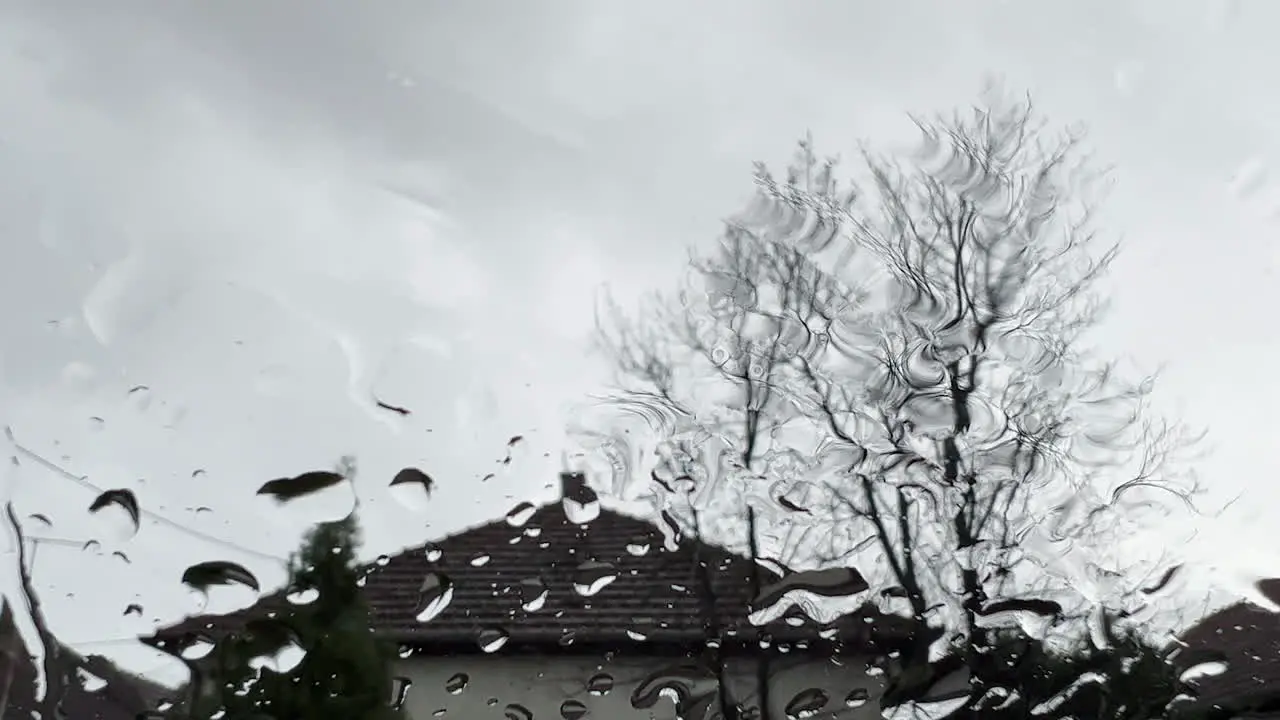 Raindrops on window pane surface as abstract background