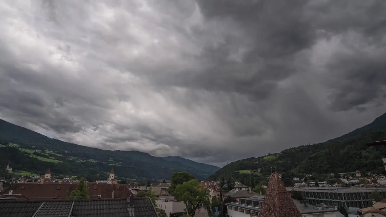 massive cloud front coming over city in the mountains a storm is coming