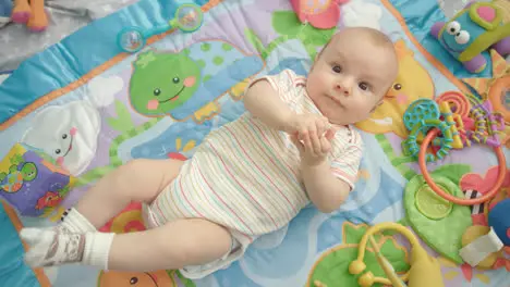 Beautiful baby lying on back Happy infant baby looking camera Lovely kid time