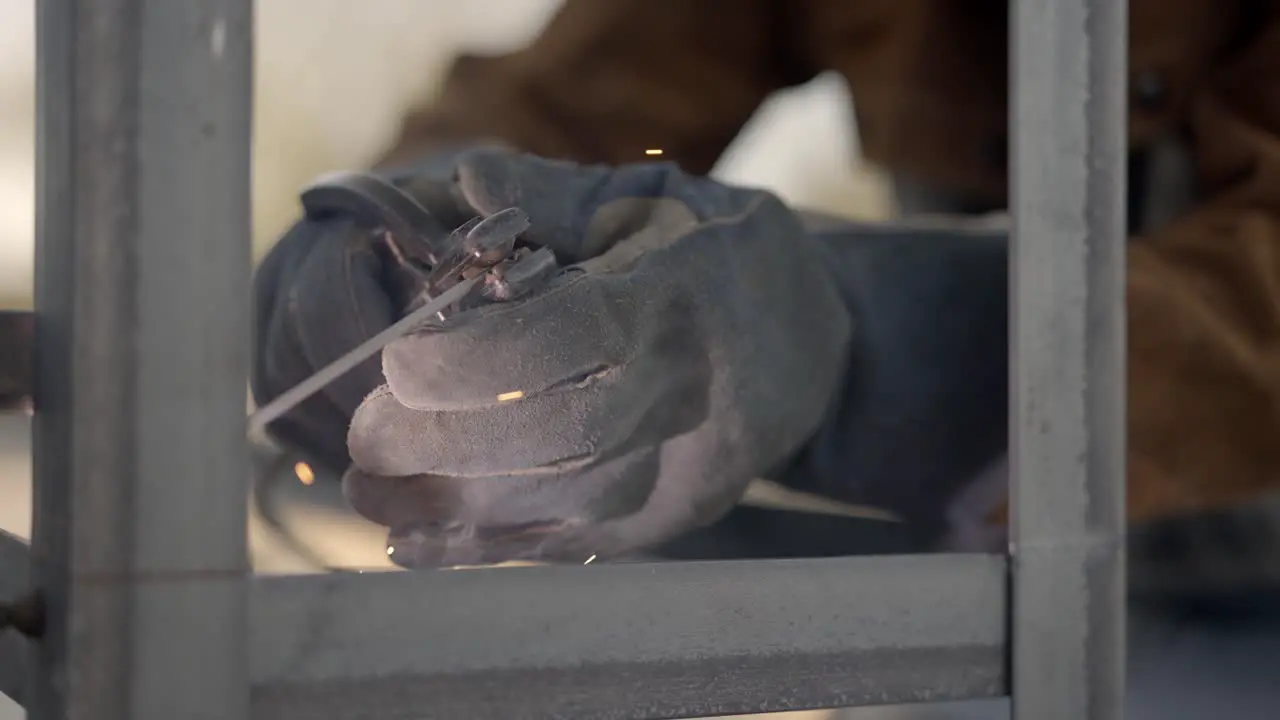 Close Up Of Welder Using Stick Welder Slow Motion Pull Back Shot