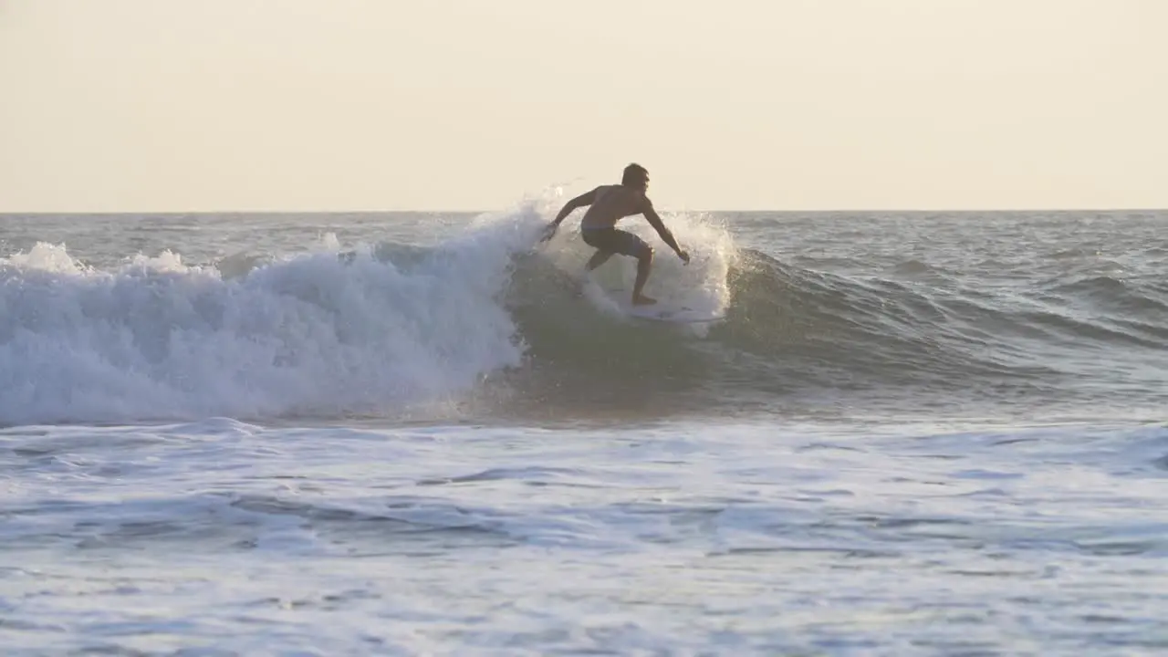 Tracking Shot of a Man Surfing a Wave