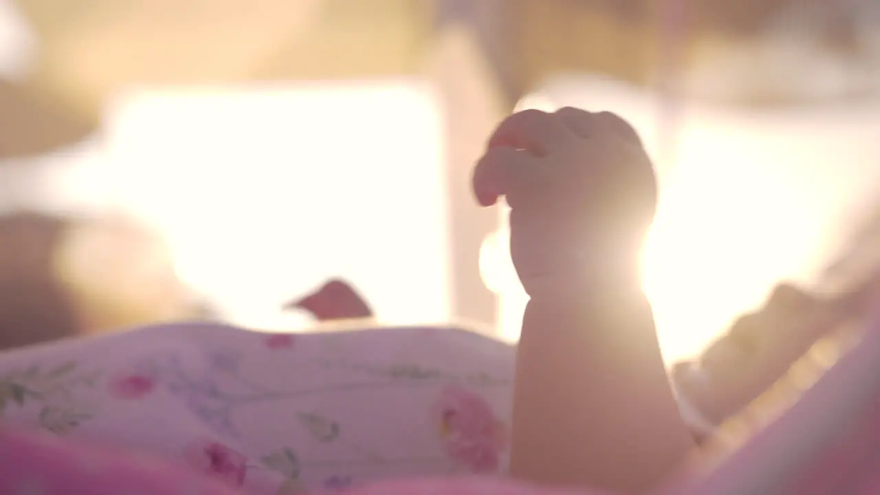 Baby moving hands view in evening sun light