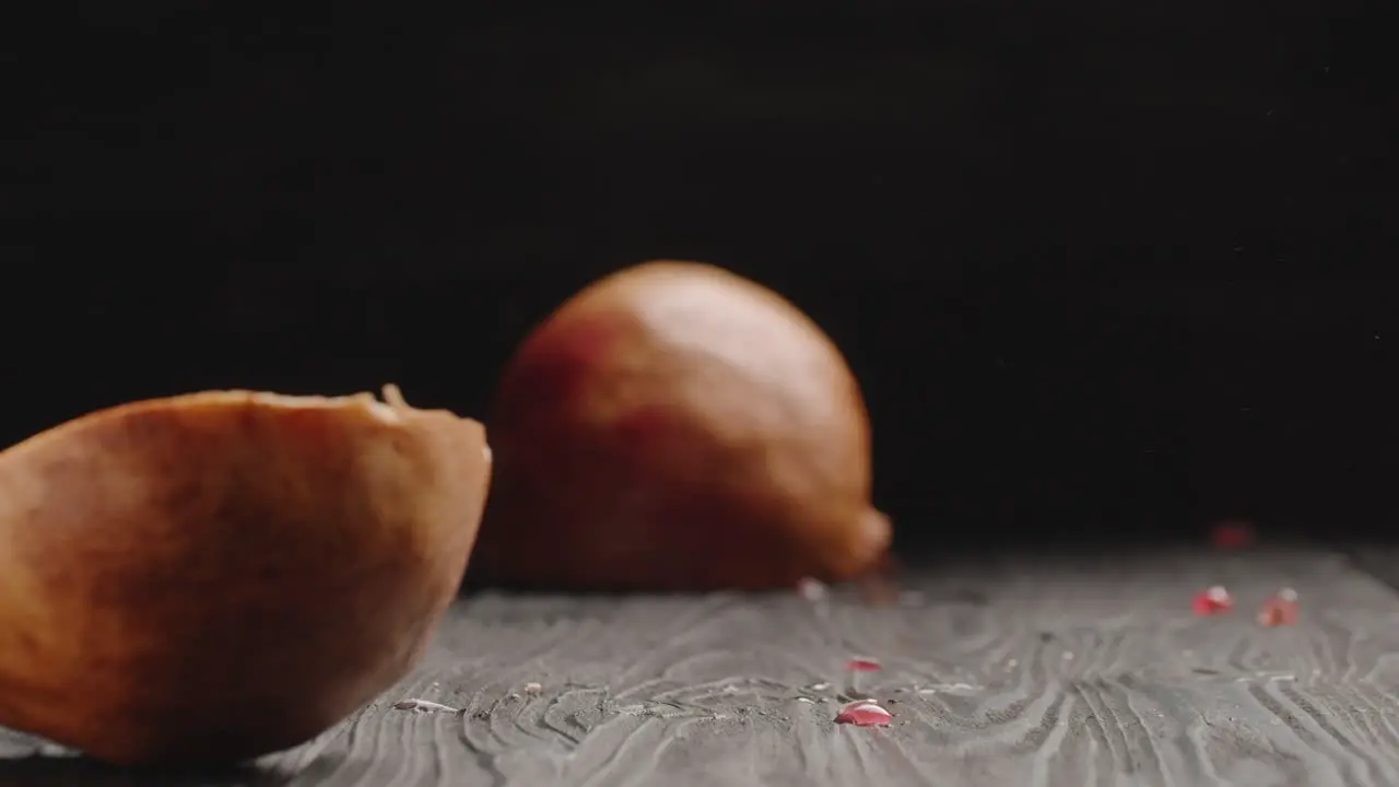 Cutting juicy pomegranate in half