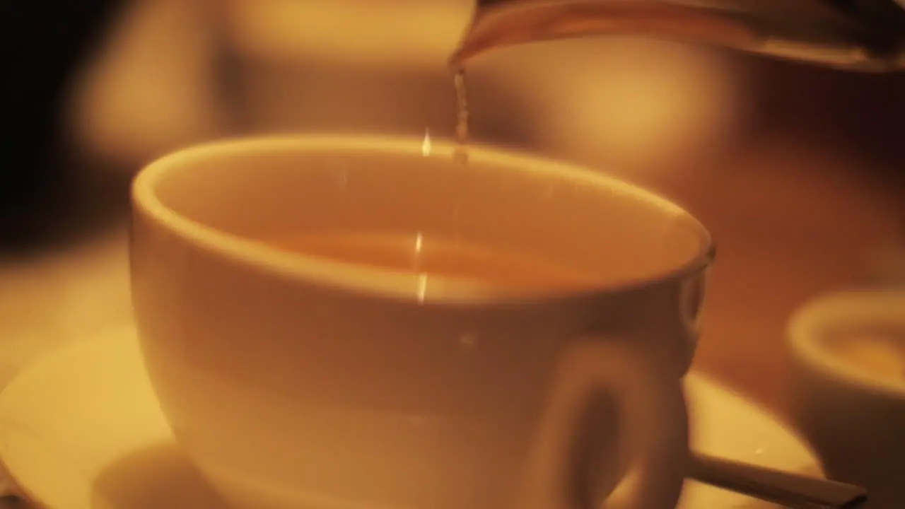 Pouring tea from glass teapot