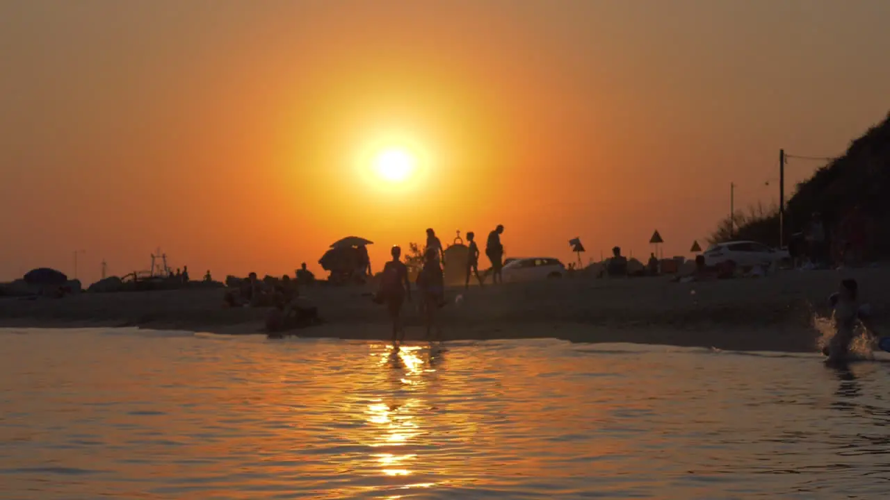 Sea and beach scene in the light of golden sunset