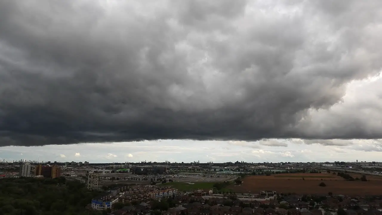 Time lapse of the dark clouds passing to form a huge thunderstorm above a city