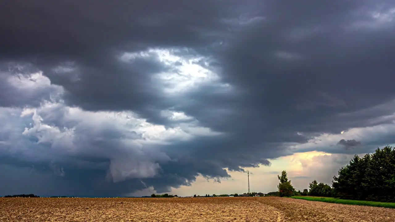 Latvia's Farmland Landscape Amidst Stormy Skies and Ominous Cumulonimbus Clouds