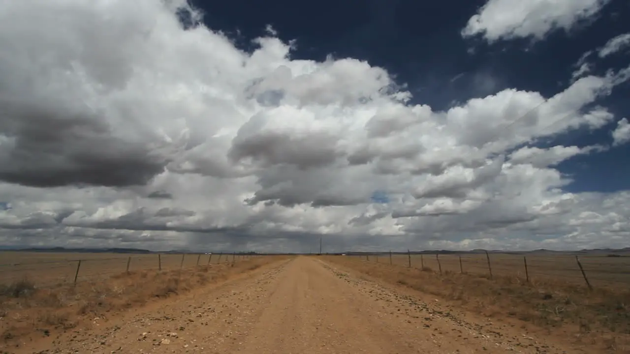 Clouds move rapidly over a lonely road