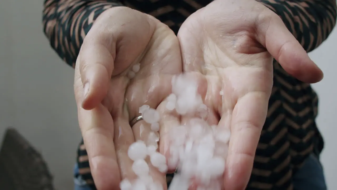 Hands with hail the result of nasty weather