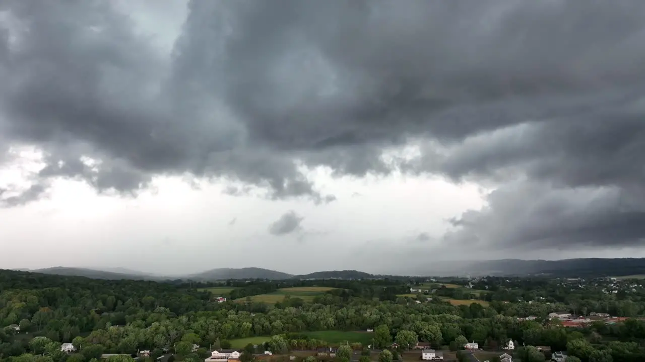 An aerial time-lapse of a large rainstorm moving over the rural countryside