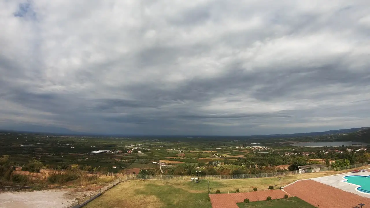 Time lapse with clouds moving fast above the green fields of northern Greece