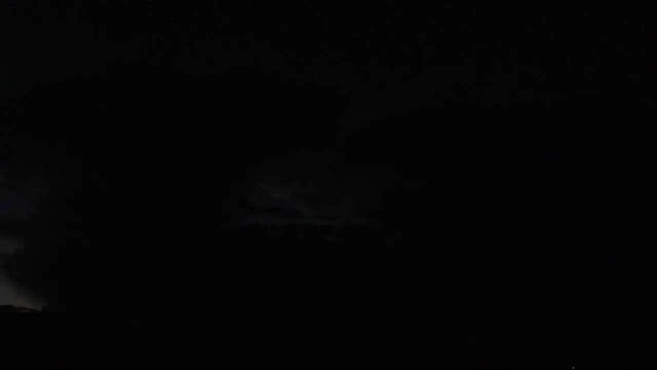 Slow Motion of a distant cloud at night with heady lightning happening inside it