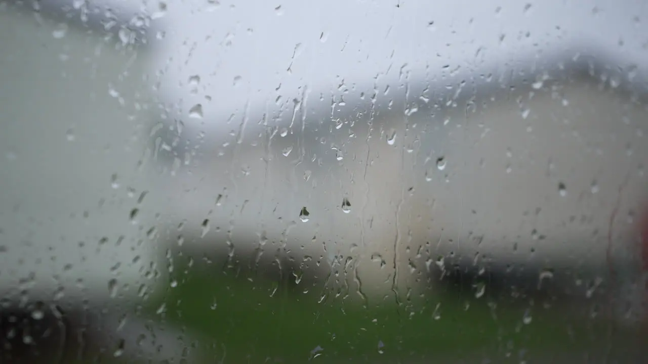 Rain droplets running down a window at a static caravan trailer holiday park in Britain