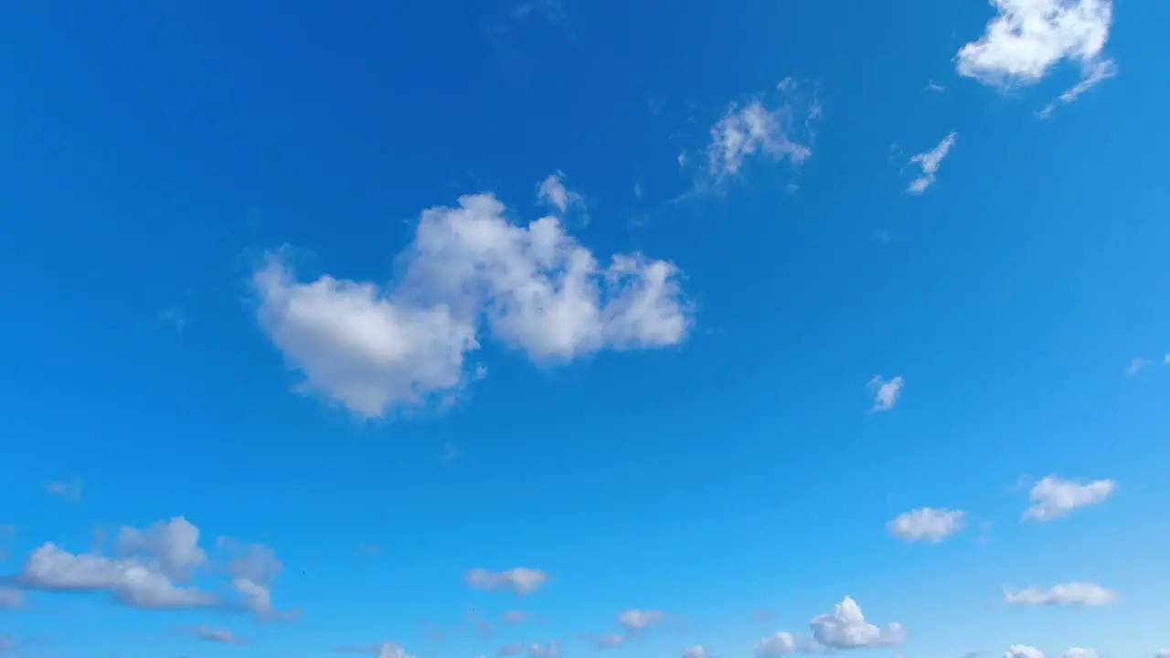 Time lapse of white puffy clouds moving in the sky