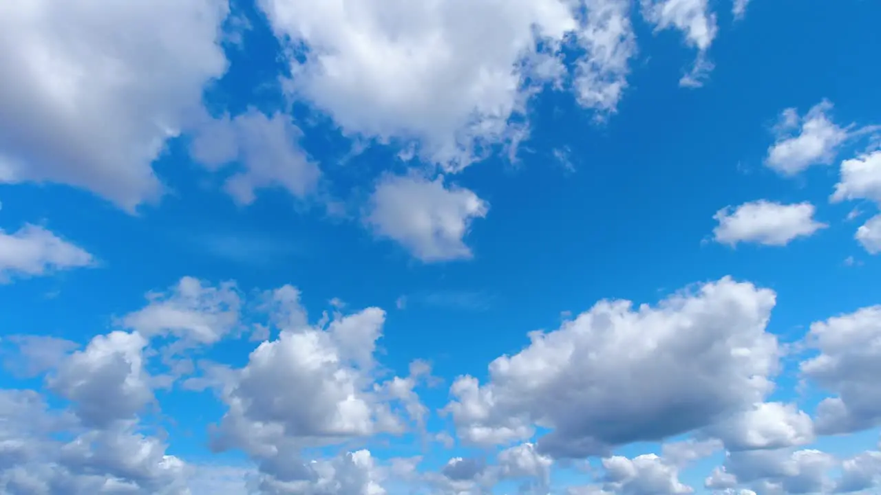 Time lapse of large white clouds moving in the sky