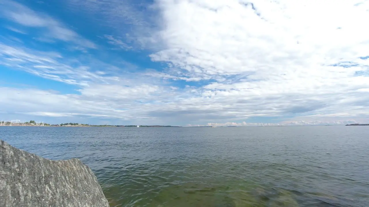 Time lapse of clouds moving over a lake with reflections