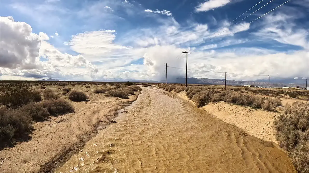 Unusual monsoon rains in the Mojave Desert fill Cache Creek with water aerial flyover reveal