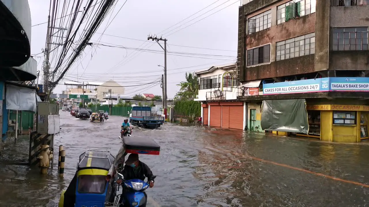 Overflow streets and highway vehicles and commuters risking driving and walking through submerged roadway