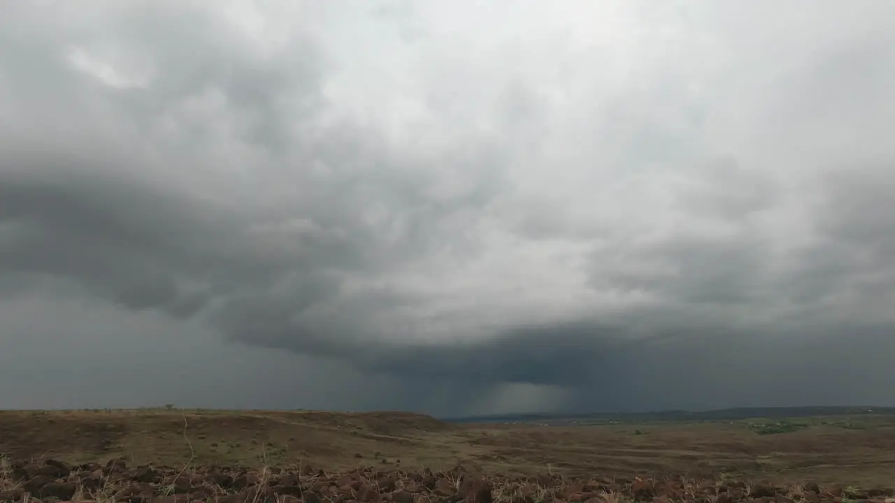 Gathering of a Huge Storm clouds in the sky over the parched Grassland rocky landscape during the start of the Monsoon season in India