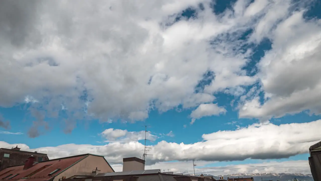 Time-lapse footage of large menacing cumulus storm clouds forming against a blue sky background indicating impending bad weather