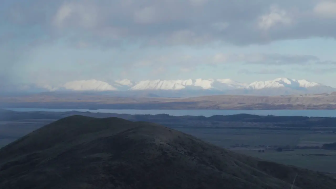 Two thumb range on horizon behind lake Pukaki storm clouds pulling in