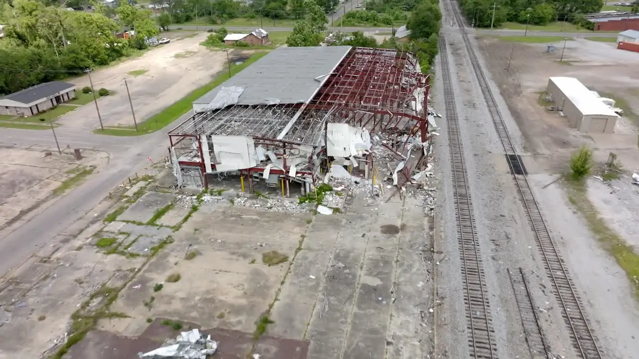 2023 Tornado damage of warehouse in Selma Alabama with drone pulling back