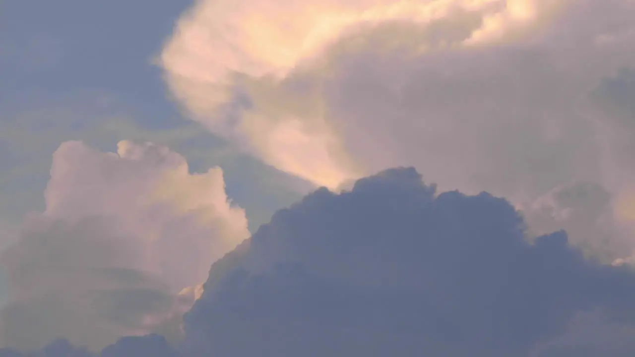 Billowing clouds cumulonembus growing a storm at the sunset