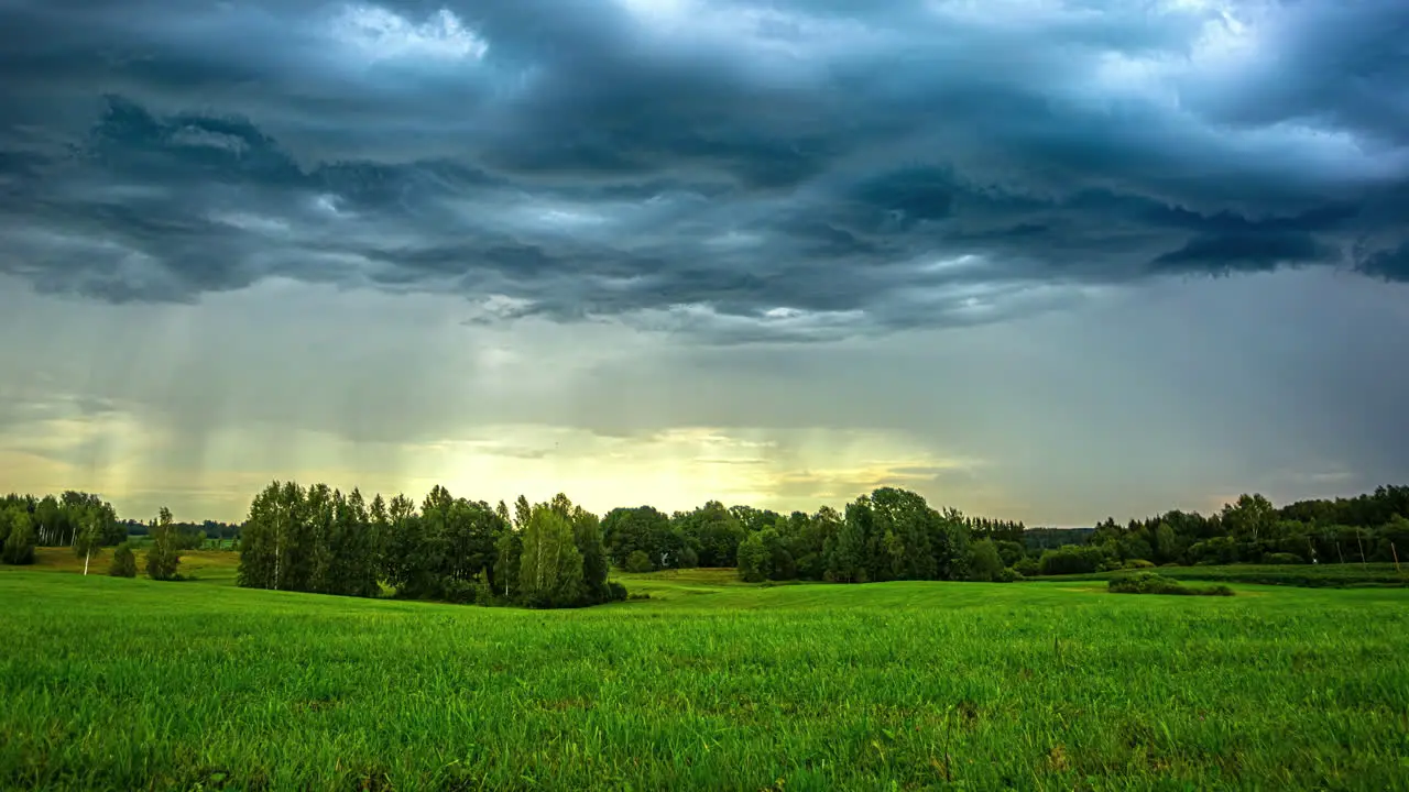 Timelapse of a storm dropping rain onto peaceful green fields