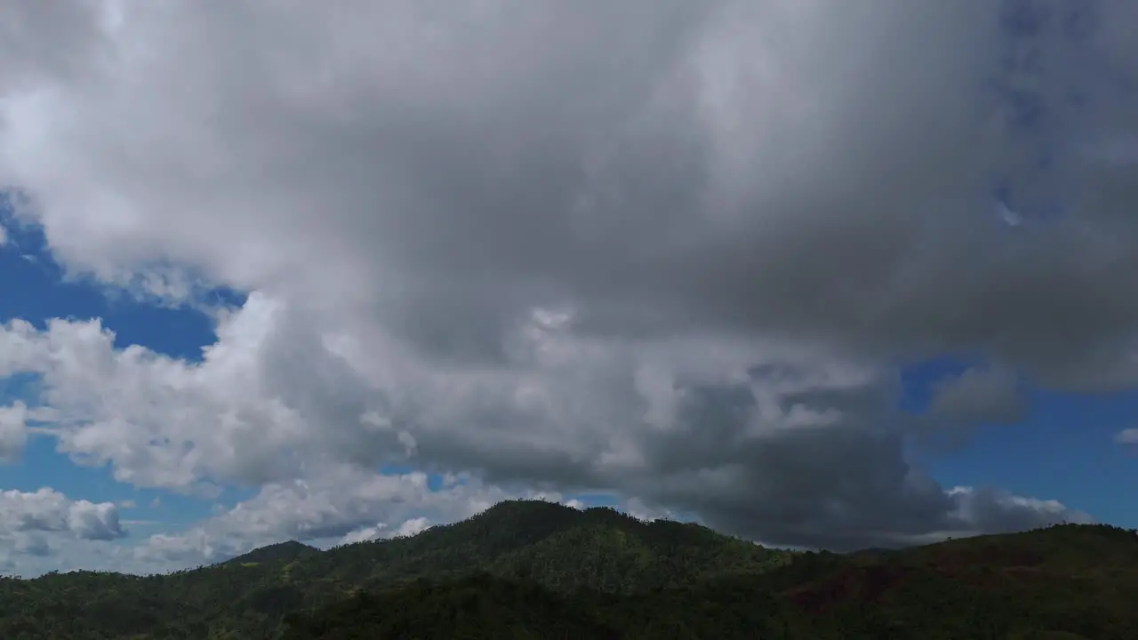 Aerial clips of dense clouds hovering over a hilly region