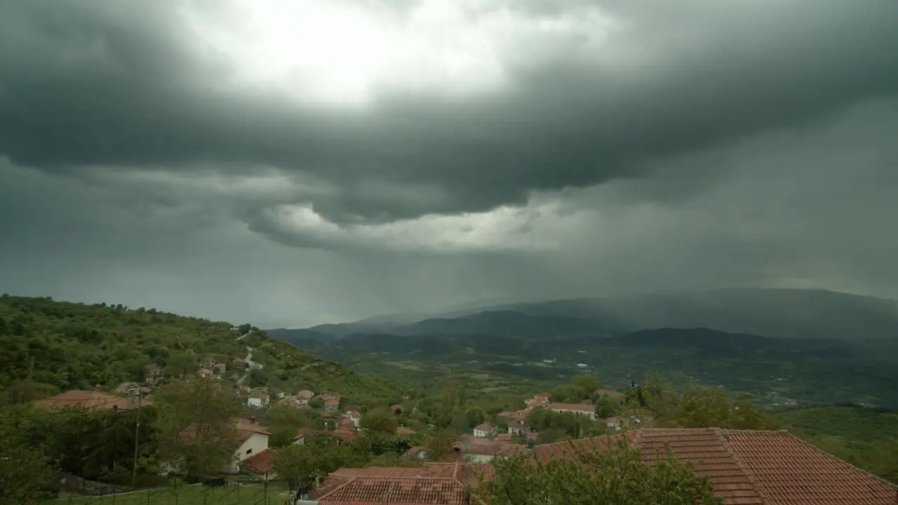 time lapse of a storm over a small village at mountain Kissavos Greece dramatic cinematic mood